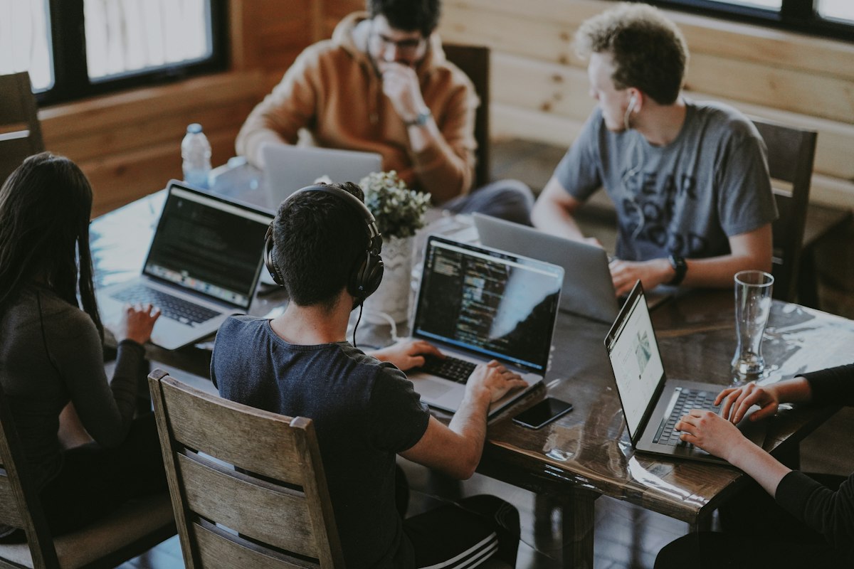 Agency team working on laptops around a shared table